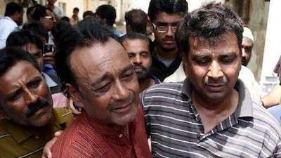 Asif Ali Khan (second from left), son of late Pakistani Ghazal singer Mehdi Hassan Khan, cries following his father's death. Mehdi Hassan Khan, also known as Pakistan's 'King of Ghazal,' died at a hospital in Karachi after a long illness.
