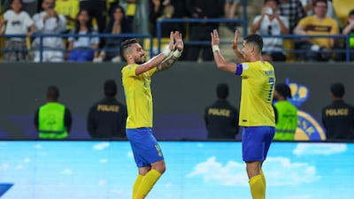 Cristiano Ronaldo celebrates with Alex Telles after scoring Al Nassr's fifth goal and completing his hat-trick. Getty Images