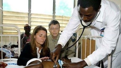 Bill and Melinda Gates visiting with a young malaria patient in Mozambique. Jeff Christensen / Reuters