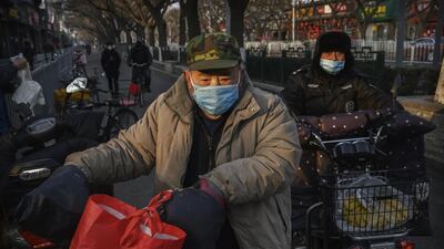 BEIJING, CHINA - FEBRUARY 19: Chinese men wear protective masks in a residential neighbourhood on February 19, 2020 in Beijing, China. The number of cases of the deadly new coronavirus COVID-19 rose to more than 58000 in mainland China Wednesday, in what the World Health Organization (WHO) has declared a global public health emergency. China continued to lock down the city of Wuhan in an effort to contain the spread of the pneumonia-like disease which medicals experts have confirmed can be passed from human to human. In an unprecedented move, Chinese authorities have maintained and in some cases tightened the travel restrictions on the city which is the epicentre of the virus and also in municipalities in other parts of the country affecting tens of millions of people. The number of those who have died from the virus in China climbed to over 2000 on Wednesday mostly in Hubei province, and cases have been reported in other countries including the United States, Canada, Australia, Japan, South Korea, India, the United Kingdom, Germany, France and several others. The World Health Organization has warned all governments to be on alert and screening has been stepped up at airports around the world. Some countries, including the United States, have put restrictions on Chinese travellers entering and advised their citizens against travel to China. (Photo by Kevin Frayer/Getty Images)