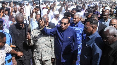 Kamil Idris, centre, Prime Minister of Sudan's military-backed government, arrives in the capital Khartoum, after the army was pushed out of the city about three years ago. AFP