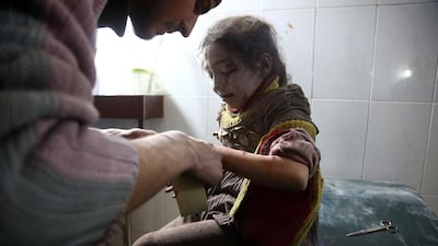 A child receives treatment at a makeshift hospital following Syrian air force strikes in the town of Hamouria in the Eastern Ghouta region on February 8, 2018. Abdulmonam Eassa / AFP