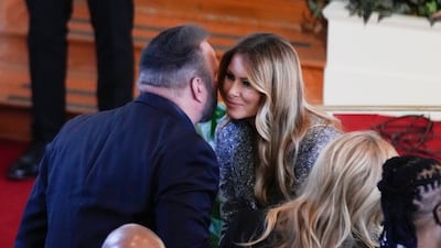 Former first lady Melania Trump speaks with Brooks during the service. AP