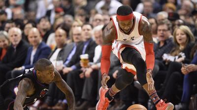 Toronto Raptors forward Terrence Ross, number 31, picks up a loose ball as LA Clippers guard Jamal Crawford, number 11, dives during first half NBA basketball action in Toronto. Frank Gunn / The Canadian Press via AP