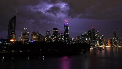 Storm clouds and lightning are seen passing over the Brisbane skyline, from the Kangaroo Point cliffs in Brisbane, Australia. Darren England / EPA.