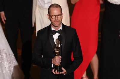 Danish-Norwegian film director and writer Joachim Trier accepts the award for Best International Feature Film for Sentimental Value. AFP
