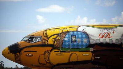 A technician works inside the Boeing 737 aircraft of Brazilian airline Gol, which will travel with the Brazilian national football team during the 2014 World Cup. Nacho Doce / Reuters / May 27, 2014