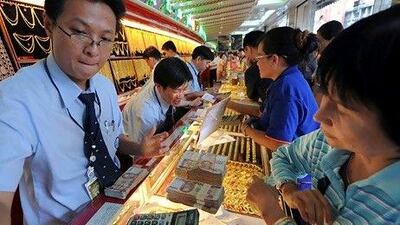 Investors are clamouring to buy gold as the yellow metal's price struck $1,894.80 per troy ounce before falling a bit yesterday. Pornchai Kittiwongsakul / AFP