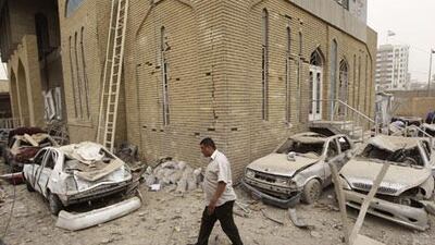 A resident walks past a site destroyed by a bomb attack near the Iranian Embassy in Baghdad on Monday, April 5, 2010.