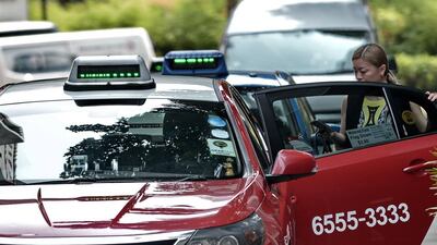 A taxi at Raffles place financial district in Singapore. The government has enlisted Delphi to run a pilot programme for driverless cars that may lead to robot cabs becoming a feature of the notoriously gridlocked city. AFP PHOTO/ROSLAN RAHMAN