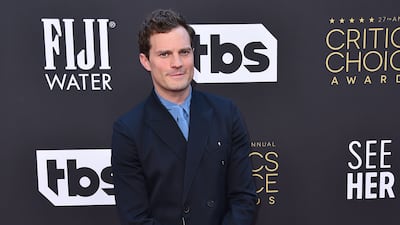 Jamie Dornan arrives wearing Valentino. AP