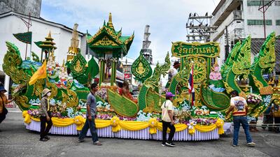 Buddhist devotees walk with a float during a parade celebrating the end of the Buddhist Lent in Thailand's southern province of Narathiwat. AFP