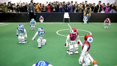 Visitors watch robot teams competing for the ball during a robot performance. Wu Hong / EPA