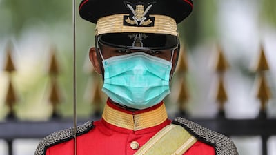 A Malaysian Royal Guard wears a protective mask while he stands guard outside National Palace, following the outbreak of a new coronavirus in China, in Kuala Lumpur, Malaysia. REUTERS