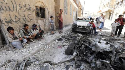 Yemenis inspect the scene of a car bomb targeting a group of female mourners loyal to the Houthis in Sanaa. Yahya Arhab / EPA