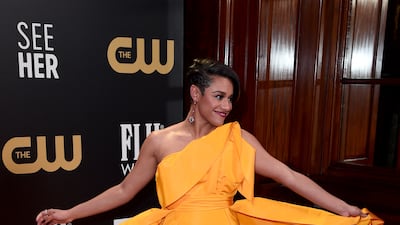Ariana DeBose attends in an orange Carolina Herrera dress. Getty Images