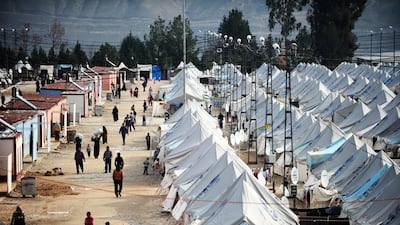 Syrian refugees walk among tents at Karkamis' refugee camp on January 16, 2014 near the town of Gaziantep in Turkey. Ozan Kose / AFP