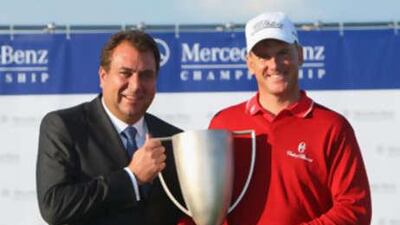 Robert Karlsson is presented with the trophy by Olaf Gottgens, the vice president of brand communication of Mercedes Benz cars.