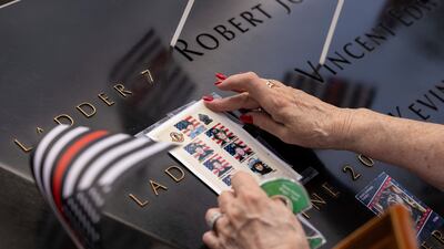 Photos of fallen firefighters are placed on the 9/11 Memorial in New York. AP