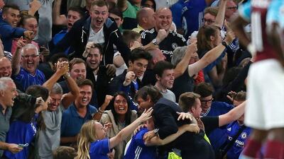 Chelsea manager Antonio Conte hugs supporters after Diego Costa's winning goal on Monday night. Ian Kington / AFP / August 15, 2016