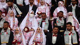 Palestinian couples attend a mass wedding in Deir Al Balah, central Gaza. But some in the enclave have paused plans to tie the knot until after the Israeli elections. Getty Images