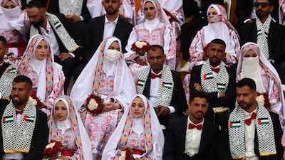 Palestinian couples attend a mass wedding in Deir Al Balah, central Gaza. But some in the enclave have paused plans to tie the knot until after the Israeli elections. Getty Images