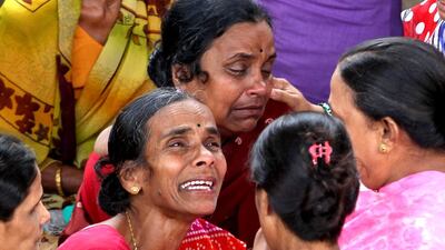 People hold vigil on Saturday at the site of a building that collapsed in Mumbai. Rajanish Kakade / AP Photo