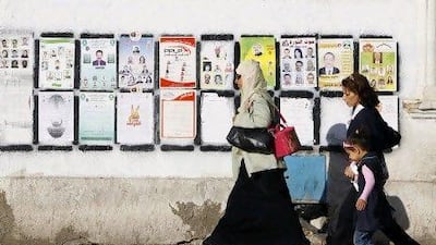 Tunisians walk past elections posters in Tunis Wednesday, Wednesday, Oct. 19, 2011 ahead of the landmark Oct. 23 election for a constitutional body that will determine the future of this North African nation which overthrew its longtime dictator in January. (AP Photo/Francois Mori) *** Local Caption *** Tunisia Elections.JPEG-06b73.jpg