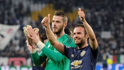 Manchester United players David de Gea and Juan Mata gesture to the crowd after their 2-1 victory over Juventus. AFP