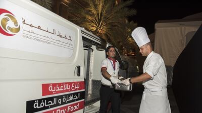 Emirates Palace executive sous chef Carmine Pecoraro gives leftover iftar food to Saving Grace, an arm of Emirates Red Crescent, to be distributed to poor people. Vidhyaa for The National