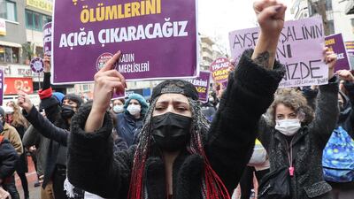 A woman holds a placard that reads, 'We will reveal suspicious female deaths' during a protest against Turkey's withdrawal from Istanbul Convention, an international accord designed to protect women. AFP