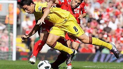 Javier Mascherano, back, tackles Arsenal's Samir Nasri.
