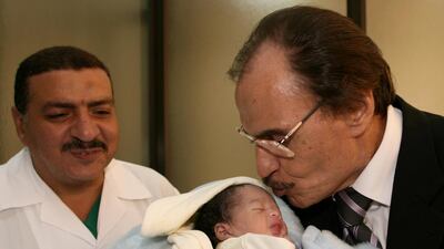 Egyptian actor Ezzat Al Alaili kisses a 5-day-old child during his visit to a hospital in Beirut, August 8, 2006. AFP