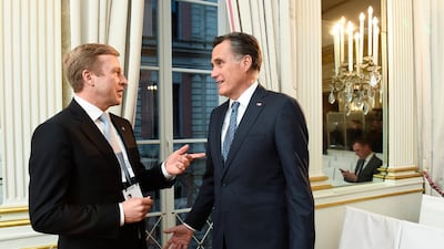 Mitt Romney, right, talks with BMW CEO Oliver Zipse during a meeting on the first day of the Munich Security Conference in Munich, Germany. AP Photo