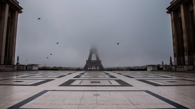 The empty Trocadero esplanade and the Eiffel Tower partially hidden by fog in Paris. AFP