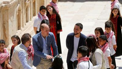 Britain's Prince William gestures as he talks with children in the ancient city of Jerash, Jordan. Reuters