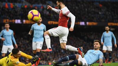 Sead Kolasinac of Arsenal is foiled by Kyle Walker and Ederson of Manchester City. Getty Images