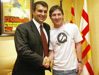 Joan Laporta, in his first spell as Barcelona president, shakes hands with Lionel Messi after the Argentine attacker signed a contract extension in 2005. AFP