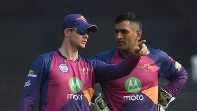 Rising Pune Supergiant captain Steve Smith, left, confers with wicketkeeper MS Dhoni during the Indian Premier league First Qualifier against Mumbai Indians at Wankhede Stadium in Mumbai, India, on May 16, 2017. Indranil Mukherjee / AFP