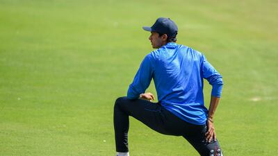 Navdeep Saini stretches during a training session. AFP