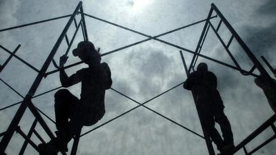 Labourers work on a building construction in Bangkok. Thailand’s gross domestic product expanded by 0.4 per cent year-on-year growth in the second quarter of 2014. Rungroj Yongrit / EPA