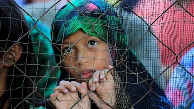 A girl, who escaped the fighting in Marawi, waits for an aid package at the gate of the relief centre in Baloi, Lanao Del Norte, Philippines. Romeo Ranoco / Reuters