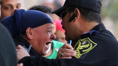 A relative of one of the blast victims screams at a police officer in front of St Mark’s Cathedral after an explosion inside the Coptic Orthodox church in Cairo. Mohamed Abd El Ghany / Reuters