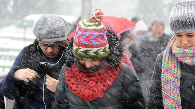 People walk in wintery weather in Istanbul. Ozan Kose / AFP Photo