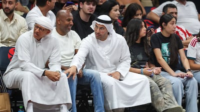 Khaldoon Al Mubarak, CEO of Mubadala Investment Company, right, watches the game from courtside.