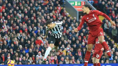 Newcastle's Joselu, left, and Liverpool's van Dijk jump for the ball. AP Photo