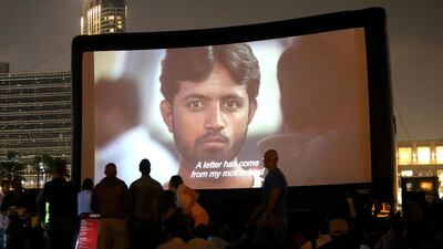 Dubai residents watch the screening of the film Camp Ka Champ at the Burj Park last week. Satish Kumar / The National