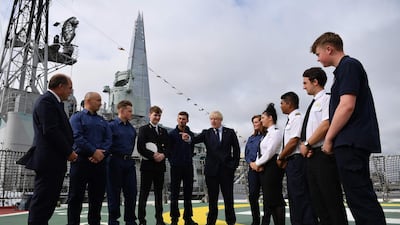Britain's Prime Minister Boris Johnson (C) has announced he is awarding a £1.3bn contract to build five new warships to a UK firm during London International Shipping Week in London. AFP