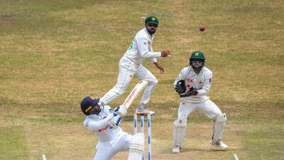 Sri Lanka's Dhananjaya de Silva plays a shot as Pakistan wicketkeeper Mohammad Rizwan and captain Babar Azam look on. AFP