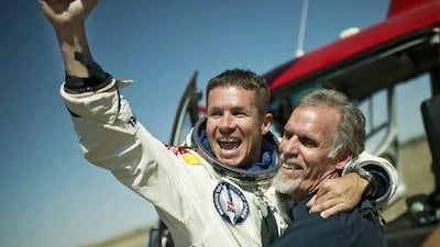 Austria's 'Fearless Felix' Baumgartner and technical project director Art Thompson celebrate after Baumgartner safely lands after jumping from his capsule about 39 kilometres from Earth.